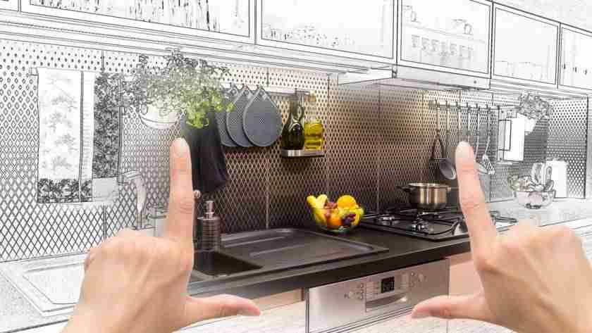 A person holding up their hands to frame part of a kitchen counter. Outside their hands, the surrounding cabinetry is a sketch.