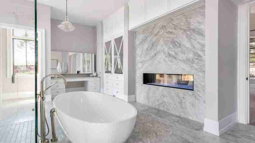 A luxurious bathroom with a large standing tub, a glass walk-in shower, and other modern features.