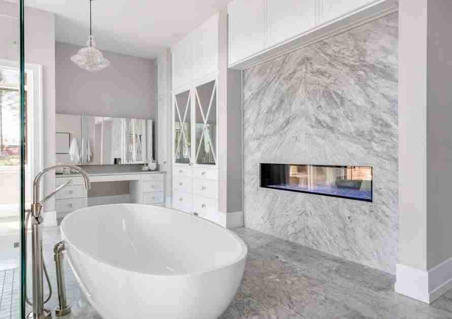A luxurious bathroom with a large standing tub, a glass walk-in shower, and other modern features.