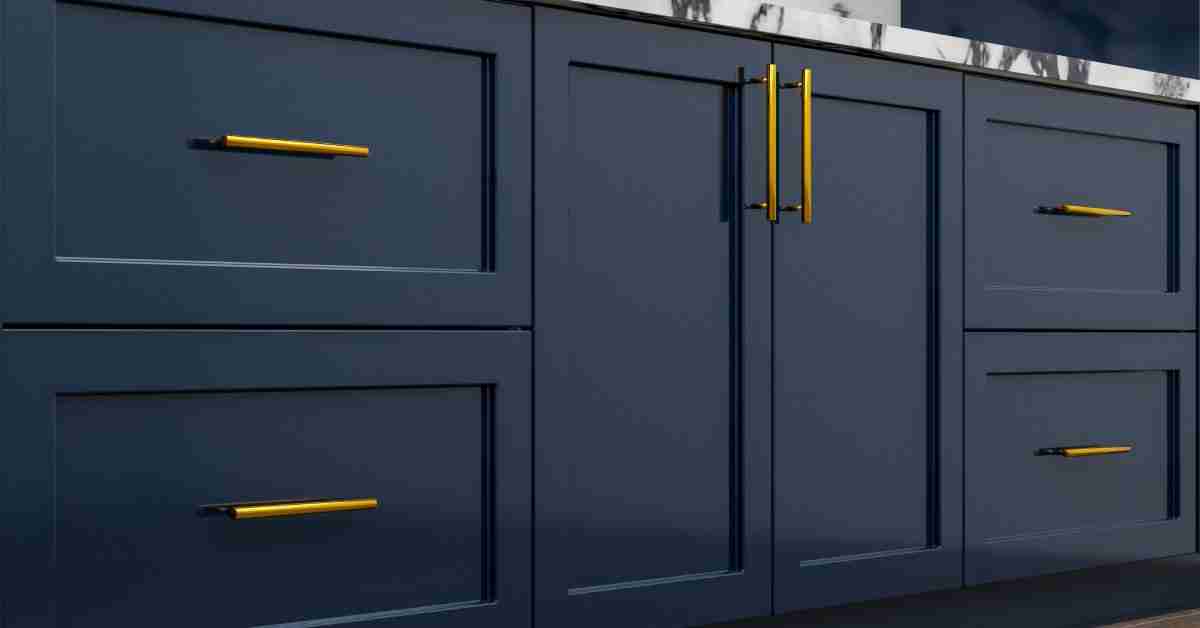 A large, clean set of navy blue cabinets with shiny, gold handles in a brightly lit residential kitchen.